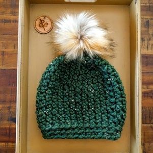 Green tweed hat with fluffy tan faux fur pompom
